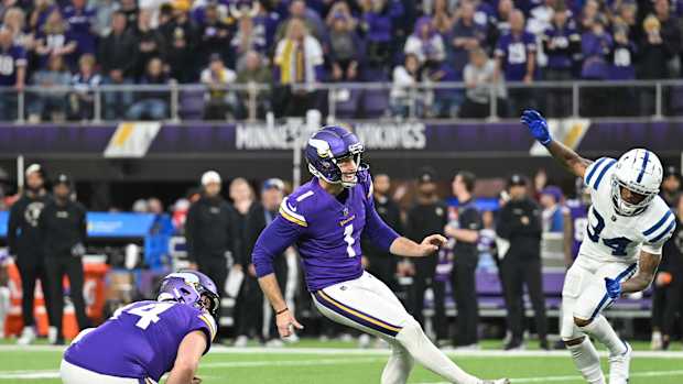 Dec 17, 2022; Minneapolis, Minnesota, USA; Minnesota Vikings place kicker Greg Joseph (1) kicks the game winning field goal as punter Ryan Wright (14) holds while Indianapolis Colts cornerback Isaiah Rodgers (34) defends during overtime at U.S. Bank Stadium. Mandatory Credit: Jeffrey Becker-USA TODAY Sports